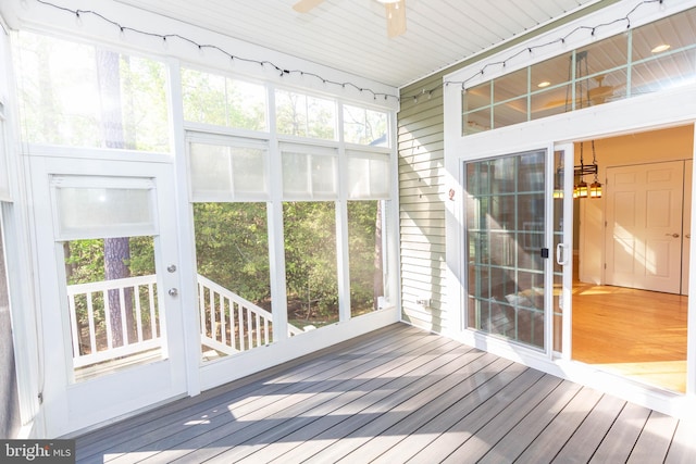 unfurnished sunroom with ceiling fan