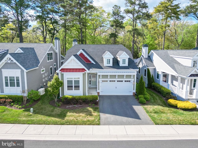 view of front of property with a garage and a front lawn