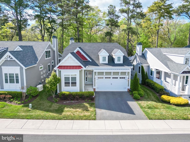 view of front of property with a garage and a front lawn