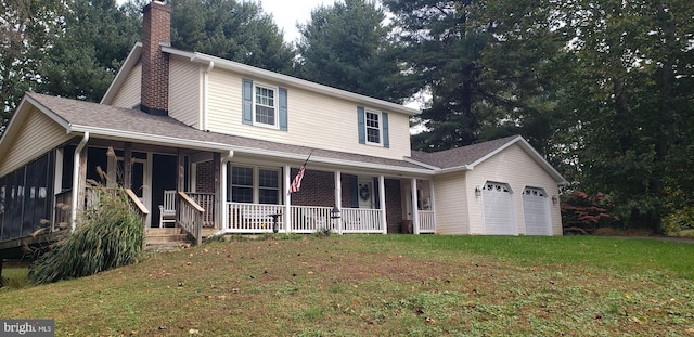 view of front of house with covered porch, a front yard, and a garage