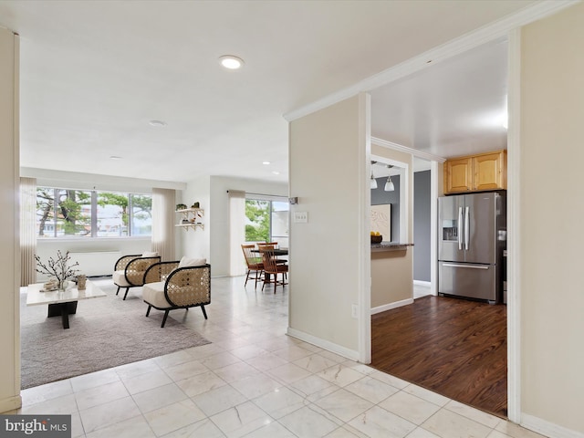 living room featuring ornamental molding and light hardwood / wood-style flooring