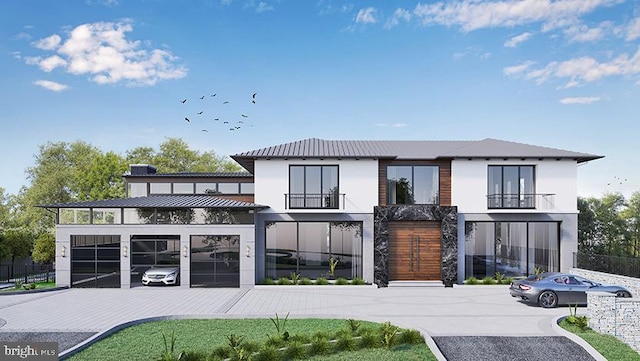 rear view of property featuring a balcony and a garage