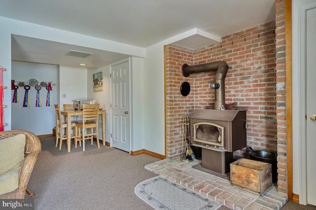 carpeted living room with a wood stove