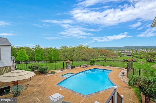 view of swimming pool with a patio and a lawn