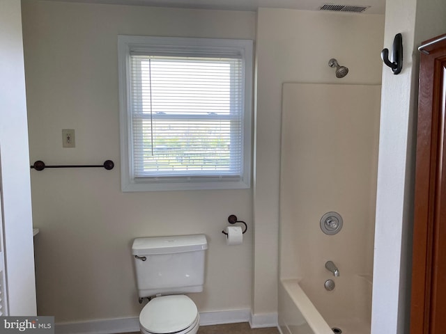 bathroom with toilet and shower / bathing tub combination