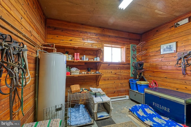 misc room with wood walls, a baseboard heating unit, and water heater