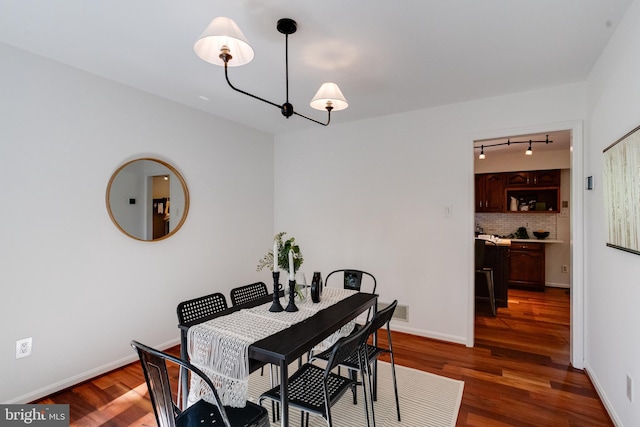 dining area with dark hardwood / wood-style floors