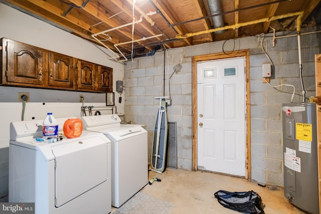 laundry room featuring water heater, washer and clothes dryer, and cabinets