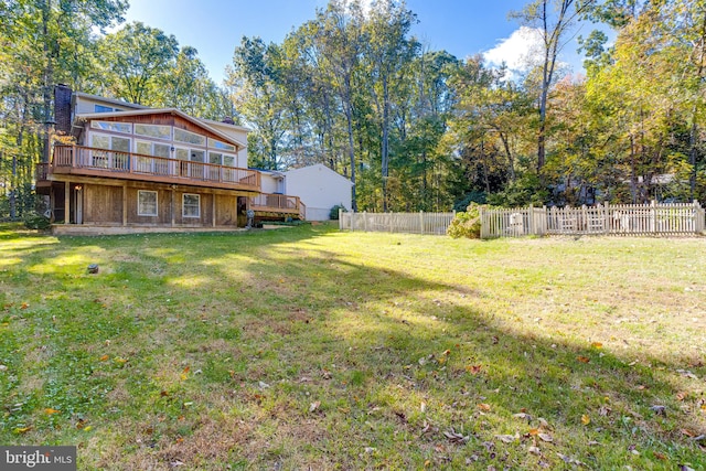 view of yard featuring a sunroom and a deck