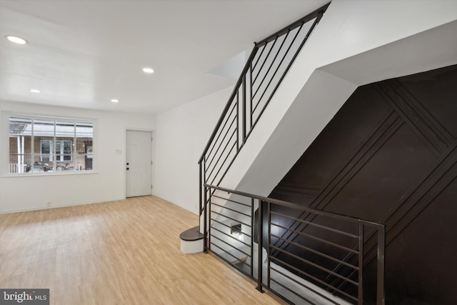 staircase featuring light hardwood / wood-style floors