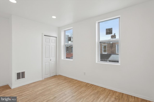 spare room featuring light hardwood / wood-style floors