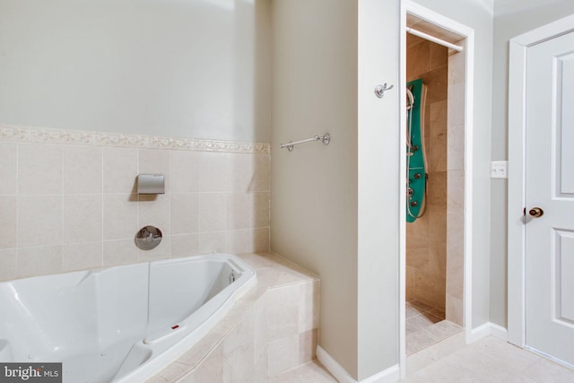 bathroom featuring plus walk in shower and tile patterned flooring