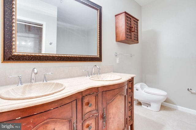 bathroom with toilet and vanity