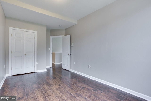 unfurnished bedroom featuring dark hardwood / wood-style floors