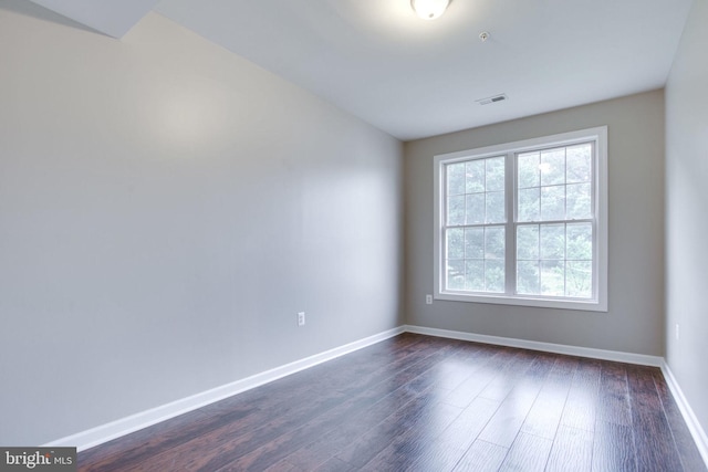 spare room featuring dark hardwood / wood-style flooring