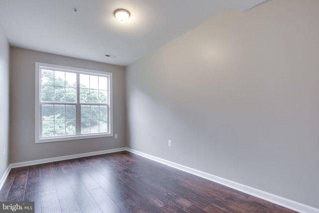 empty room with dark hardwood / wood-style floors