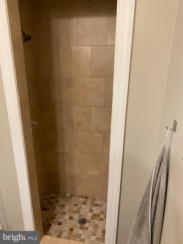 bathroom with tiled shower