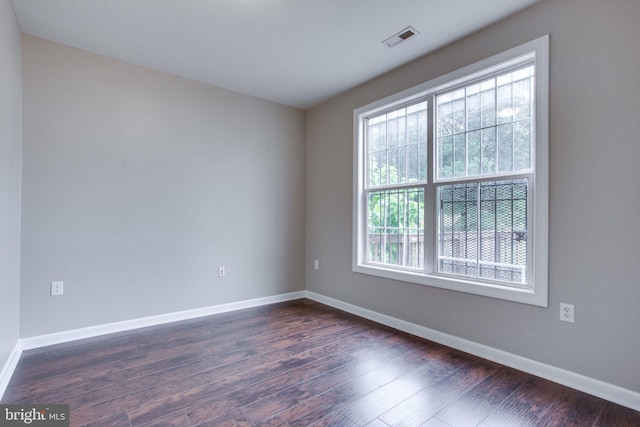 spare room with dark wood-type flooring