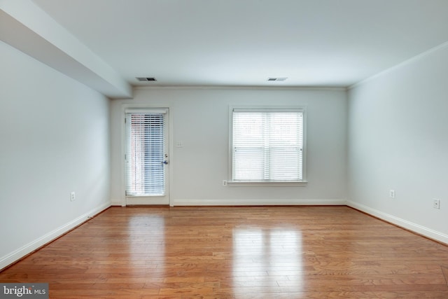 spare room with light hardwood / wood-style floors