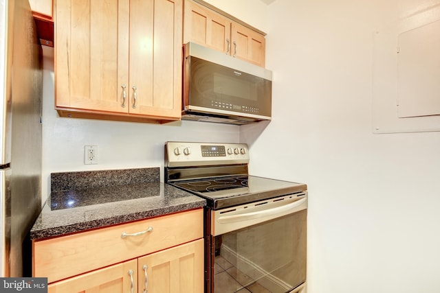 kitchen featuring tile floors, light brown cabinets, and stainless steel appliances