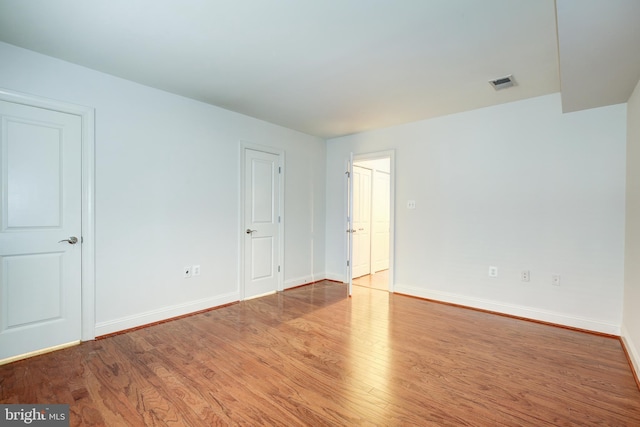 spare room featuring light hardwood / wood-style floors