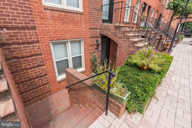 view of exterior entry featuring a patio area