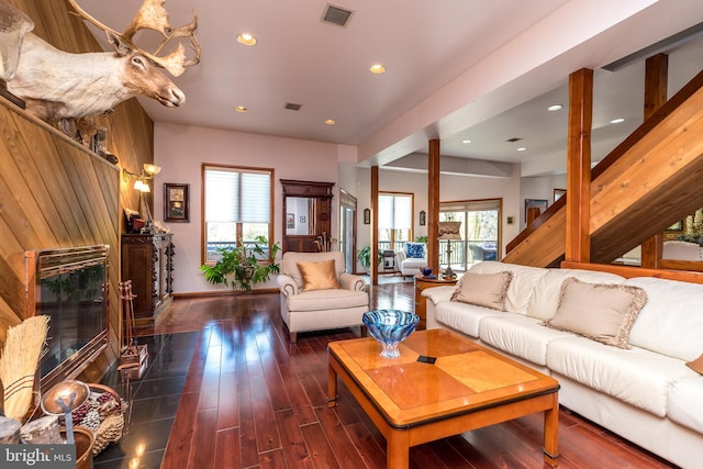 living room featuring a healthy amount of sunlight and dark hardwood / wood-style floors