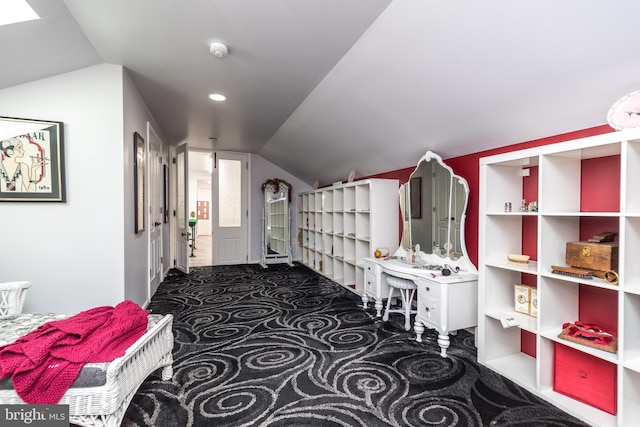 corridor with lofted ceiling and carpet