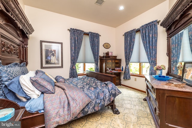 carpeted bedroom with multiple windows