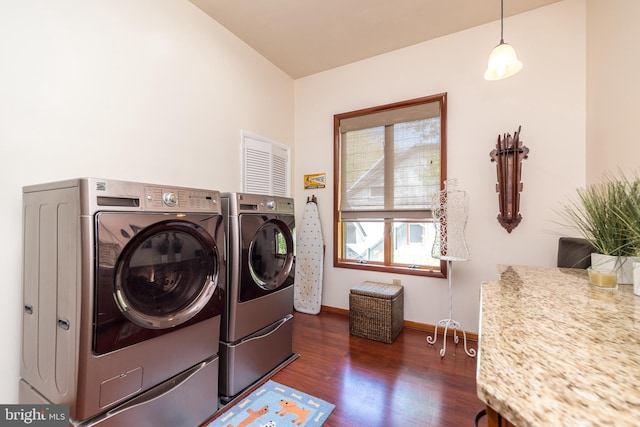 laundry room with independent washer and dryer and dark wood-type flooring