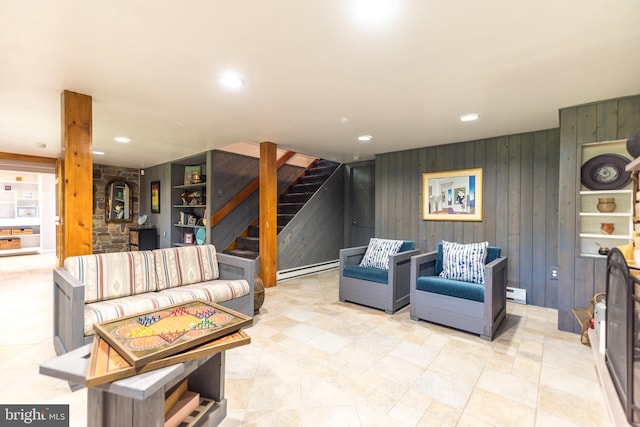 living room featuring wood walls, a baseboard heating unit, and light tile floors