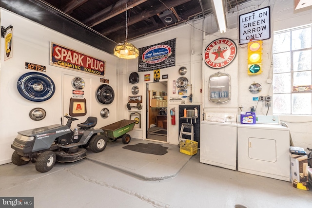 miscellaneous room with washer and dryer and concrete floors