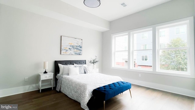 bedroom with dark hardwood / wood-style floors