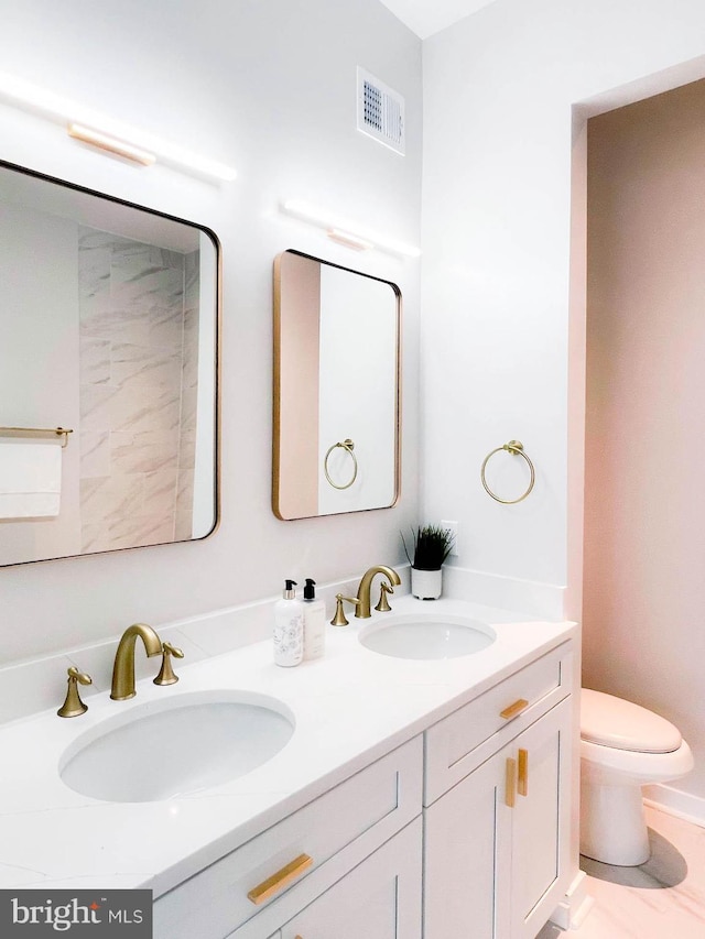 bathroom with vanity and toilet