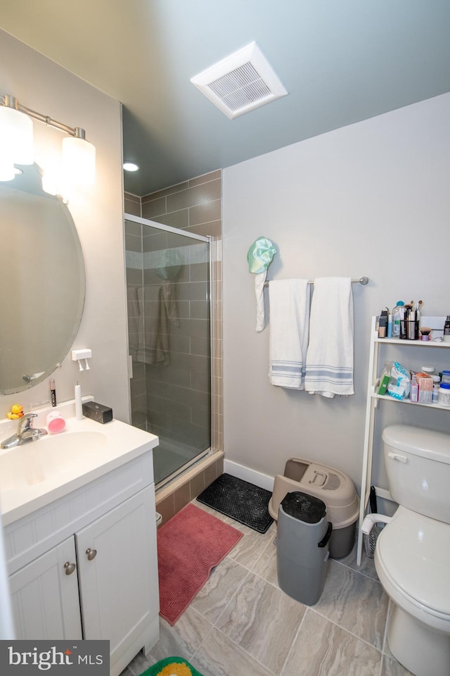 bathroom with an enclosed shower, toilet, tile floors, and vanity