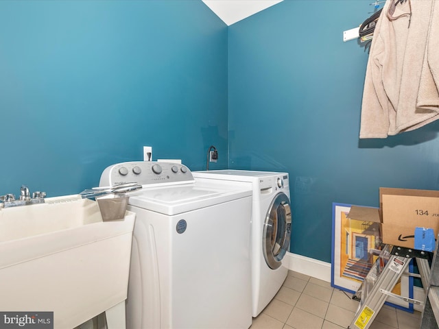 laundry room with independent washer and dryer, sink, light tile flooring, and electric dryer hookup