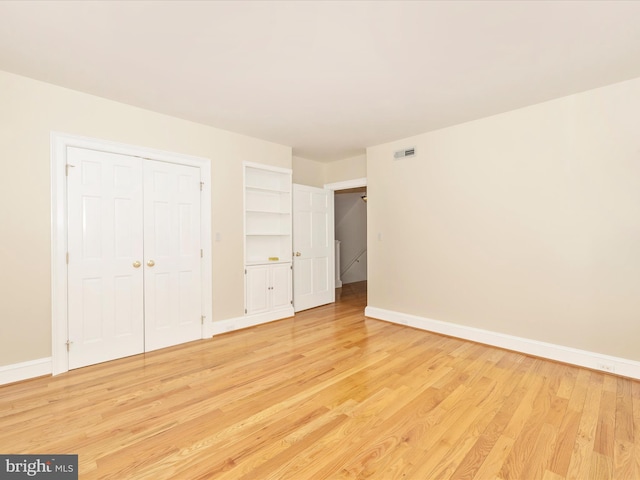 unfurnished bedroom featuring a closet and light hardwood / wood-style floors