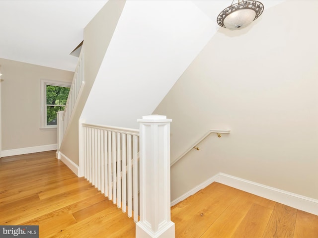 staircase with light hardwood / wood-style floors