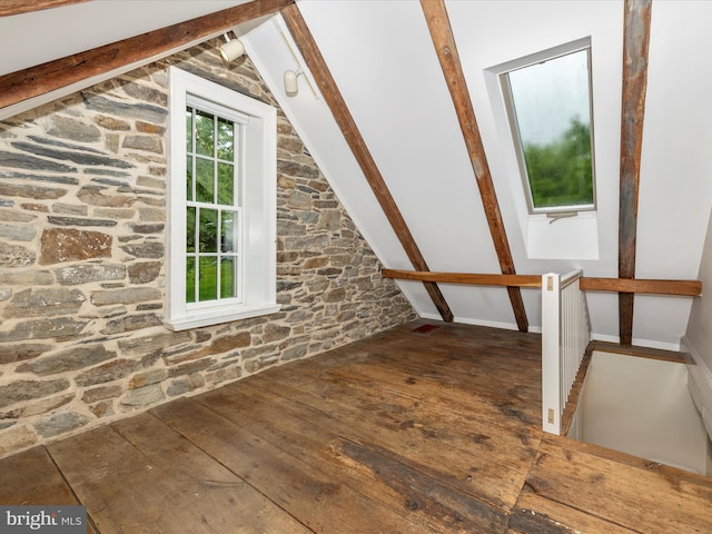 bonus room with plenty of natural light, lofted ceiling, and hardwood / wood-style flooring