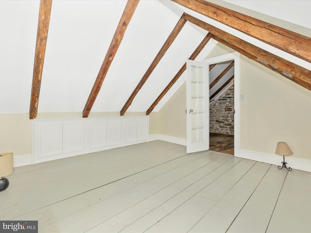 bonus room with vaulted ceiling and hardwood / wood-style flooring