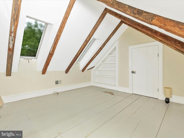 bonus room featuring hardwood / wood-style flooring and lofted ceiling