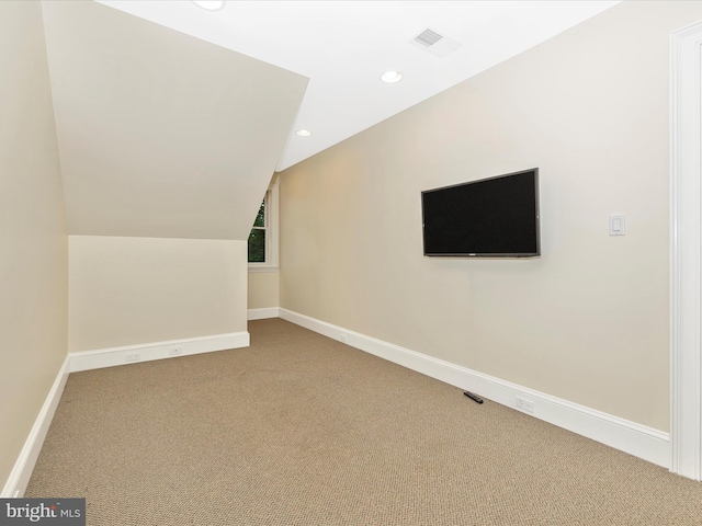 additional living space with carpet and vaulted ceiling