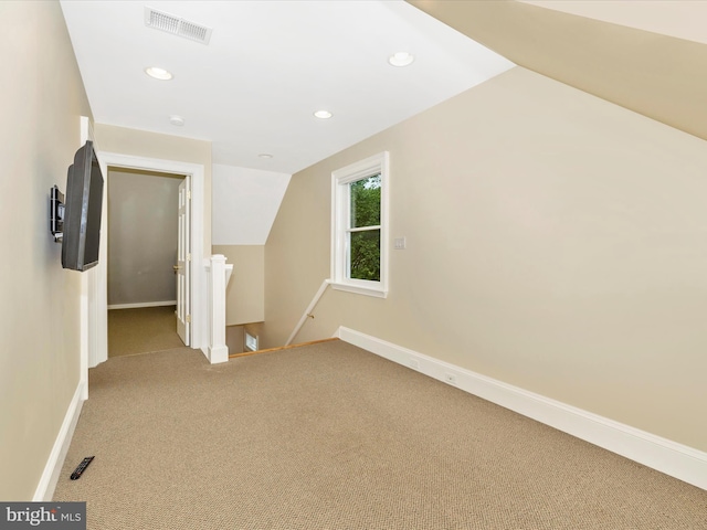 bonus room featuring carpet floors and lofted ceiling