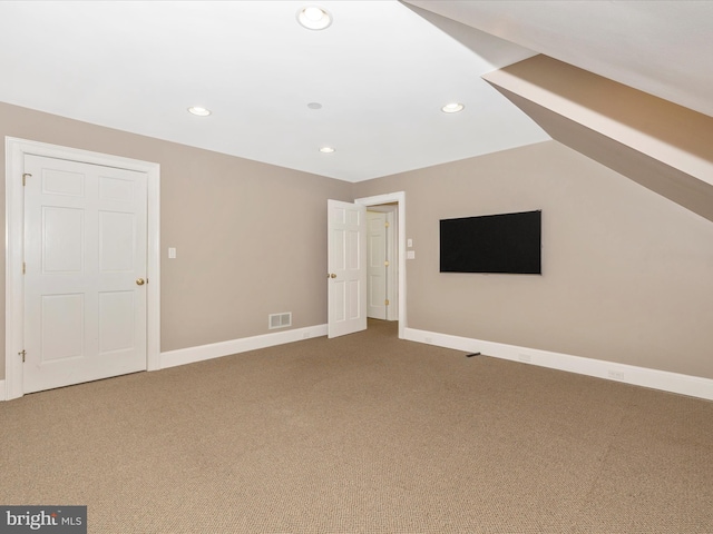 unfurnished living room featuring carpet and lofted ceiling