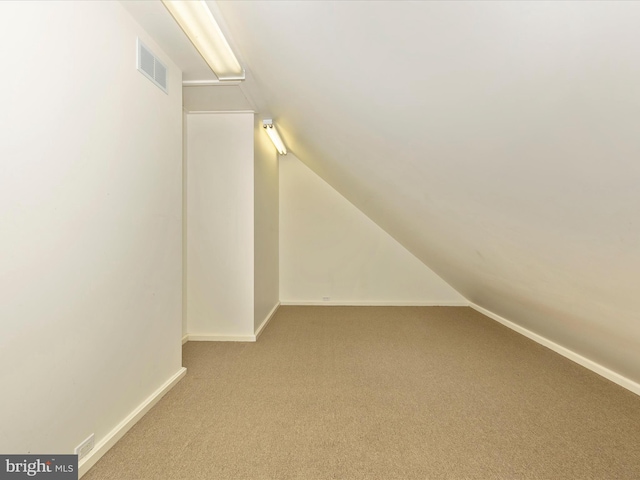 bonus room featuring carpet and lofted ceiling