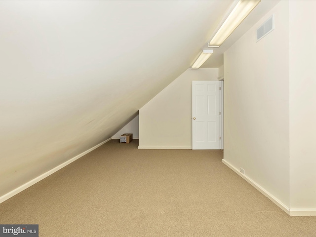 bonus room featuring carpet flooring and vaulted ceiling