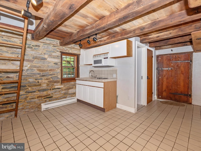 kitchen with beam ceiling, white cabinets, light tile flooring, and wood ceiling