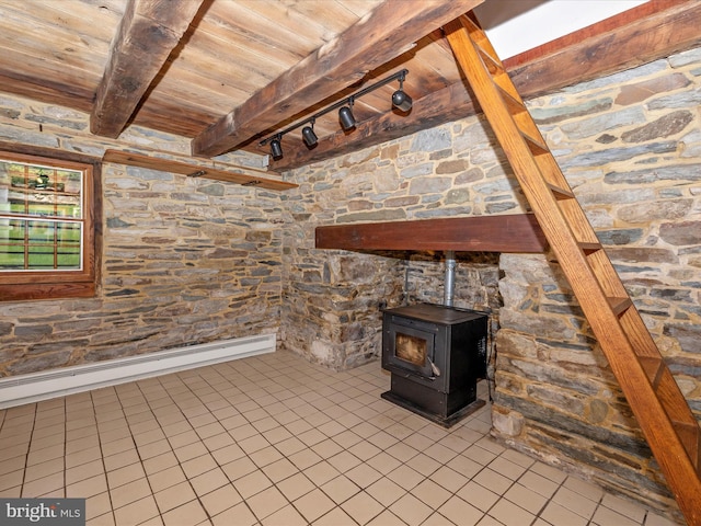 interior space with wooden ceiling, baseboard heating, a wood stove, and tile floors