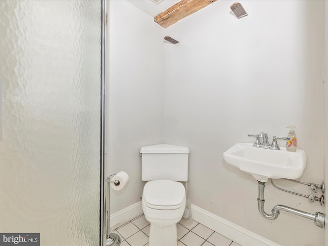 bathroom with tile flooring, sink, and toilet