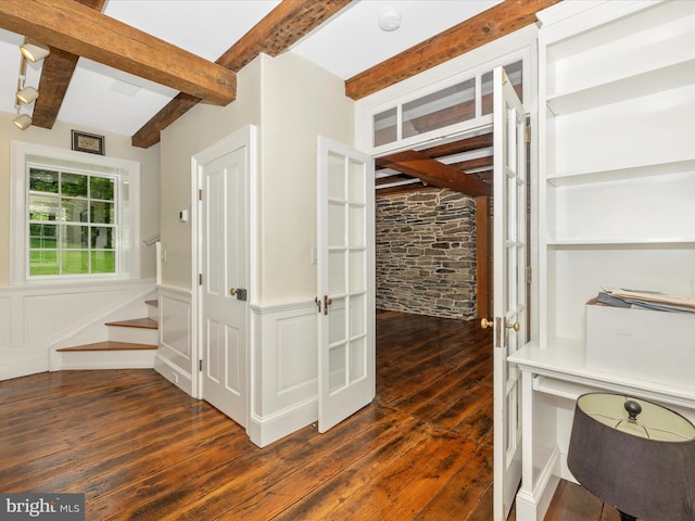 interior space featuring beamed ceiling and dark hardwood / wood-style floors